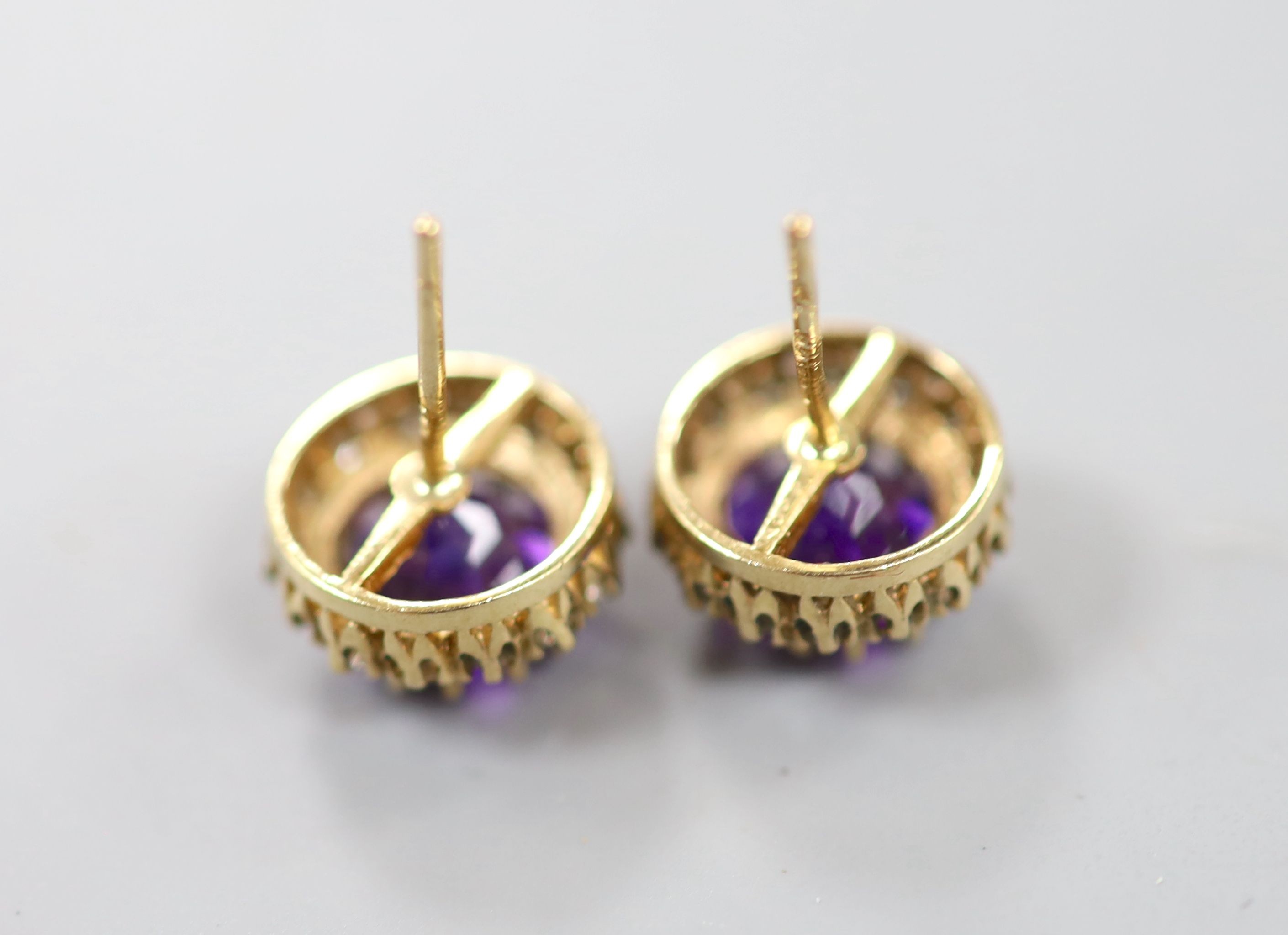 A pair of 9ct gold, amethyst and diamond chip set circular cluster ear studs (lacking butterflies), 10mm, gross weight 2.9 grams.